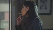 Claire Forlani smoking a cigarette