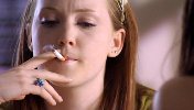Olivia Hallinan smoking a cigarette